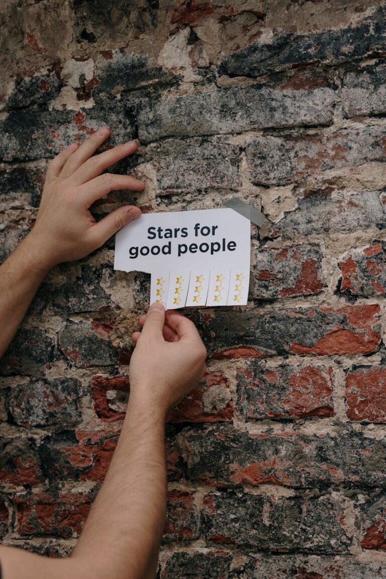 person holding a paper taped on a wall
